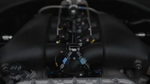 Cinematic close-up of a high-performance engine with custom fuel lines Stock Footage 335075556