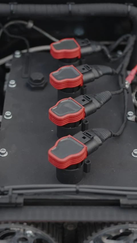 Cinematic close-up of high performance red ignition coils on engine Stock Footage 335076089