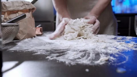 Cinematic close up kneading dough on table by professional artisan baker ba.. Stock Footage 272466839