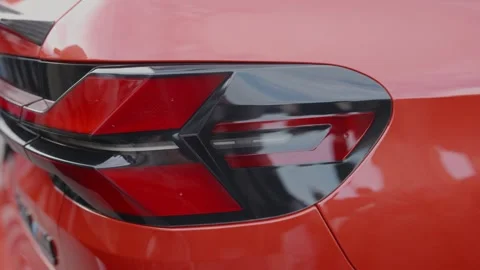Cinematic close-up of modern orange car tail light sleek design Stock Footage 335076181