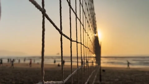 Cinematic Close up Motion through Beach Volleyball Net rope in foreground at Stock Footage 342581846