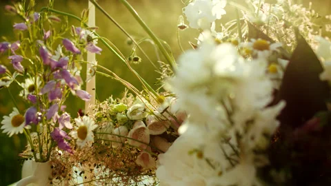 Cinematic close-up of a rustic wedding table decor with wildflowers at sunset. Stock Footage 321278603