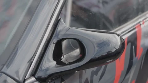 Cinematic close-up of sleek black racing side mirror on car Stock Footage 335076230