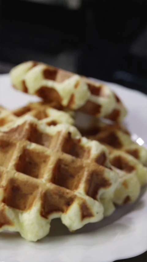 Cinematic close up of taking fresh steaming waffles out of baker grid Stock Footage 336902502