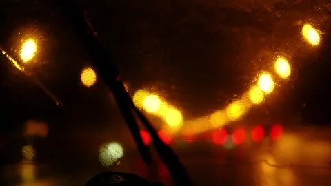 Cinematic close-up through a rain-covered car windshield at night 库存影片 342142011