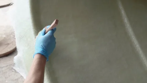 Cinematic Close-Up of Worker Hand Doing Composite Layup in Boat Manufacturing Stock Footage 323180124