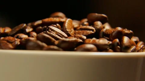 Cinematic closeup of roasted coffee beans in warm low light Stock Footage 323111944