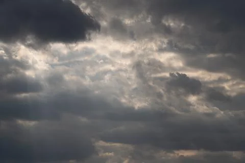 Cinematic clouds with light beams piercing sky, sweeping rays creating crepus Stock Photos