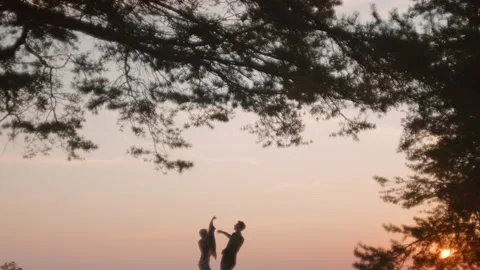 Cinematic couple slowly dance at sunset beach Stock Footage 168096474