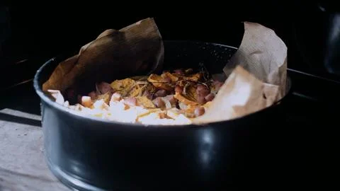 Cinematic culinary close-up: arranging the mixture in a baking dish Stock Photos