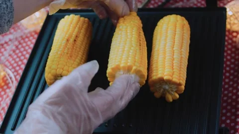 Cinematic culinary study: grilling whole corn until golden Stock Footage 342171071