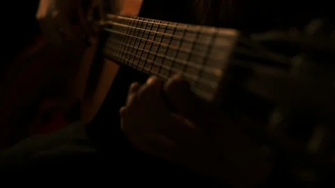 Cinematic dark key, blue light close up hands playing classical guitar Video stock 304457236