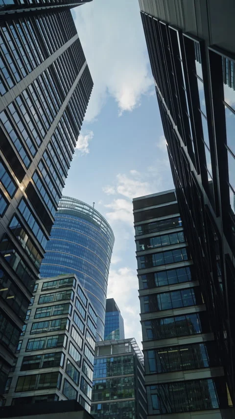 Cinematic dolly movement between modern glass skyscrapers in business district Stock Footage 335731590