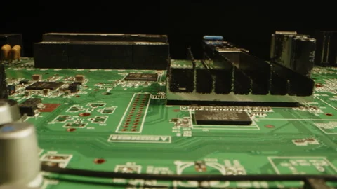 Cinematic dolly of a printed circuit board with components in a dark studio Video stock 315630571