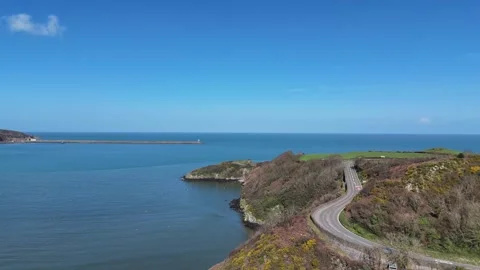 Cinematic Drone Flight Along Lower Town Coastline with coastal road, Wales Stock-Footage 332072307