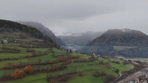 Cinematic Drone Flight Approaching a Quiet Alpine Village with Lush Gree Stock Footage 331746530