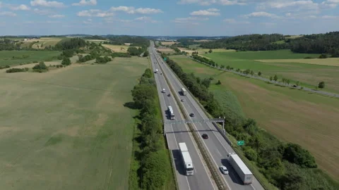 Cinematic drone flight over a bustling highway Stock Footage 263510983