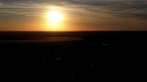 Cinematic Drone Flight Over Dark Landscape During Golden Sunset Stock Footage 346793691
