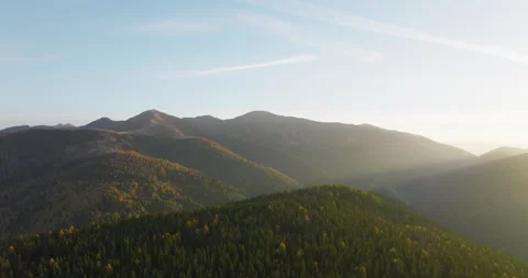 Cinematic drone flight over a forrest hill by sunset in autumn 5k Stock Footage 221839122