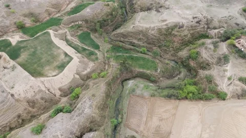 Cinematic Drone Flight Over Irrigated Farmland and Eroded Ravines in SouthAsia 스톡 동영상 332122549