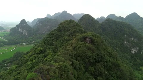 Cinematic Drone Flight over Misty Limestone Peaks in Ninh Binh, Vietnam Stock Footage 326664507