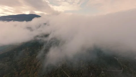 Cinematic drone flight over a misty mountain pass and autumn forest Stock Footage 328417666