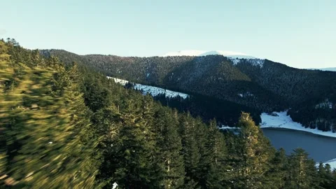 Cinematic drone flight over mountain lake and snowy summits Vídeos de archivo 326220507