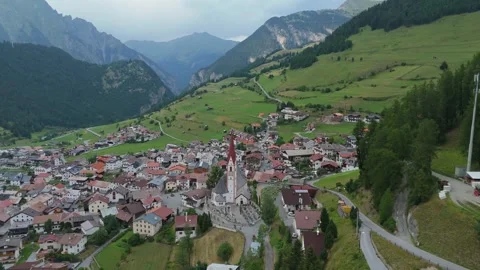 Cinematic drone flight over Nauders village revealing alpine valley in Austria Stock Footage 340773010