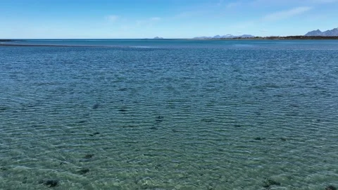 Cinematic drone flight over the ocean to the mountains in the distance Stock Footage 224018262