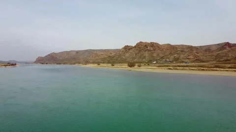 Cinematic drone flight over the River and blooming desert steppe in Central Asia Stock Footage 331574002
