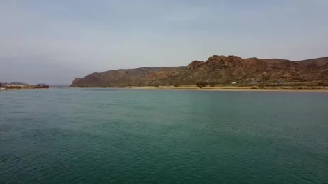 Cinematic drone flight over the River and blooming desert steppe in Central Asia Stock Footage 331574012