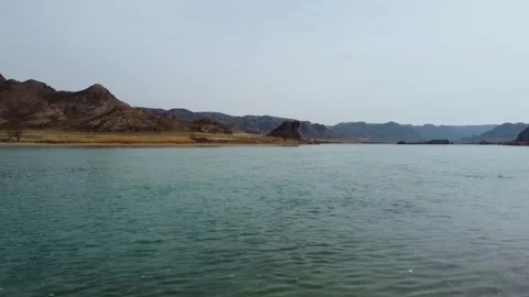 Cinematic drone flight over the River and blooming desert steppe in Central Asia Stock Footage 331574044