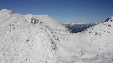 Cinematic Drone Flight Over Snow Covered Mountain Range and Valleys Vídeo Stock 332127413
