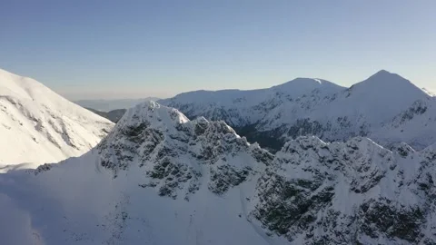 Cinematic Drone Flight Over Snow Covered Mountain Range and Valleys Stock Footage 332127439