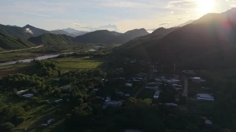 Cinematic drone flight over tropical rural village and farmland in Vietnam Stock Footage 337948471