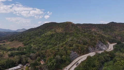 Cinematic Drone Flight Over Winding Road in Verdant Valley Stock Footage 327507600