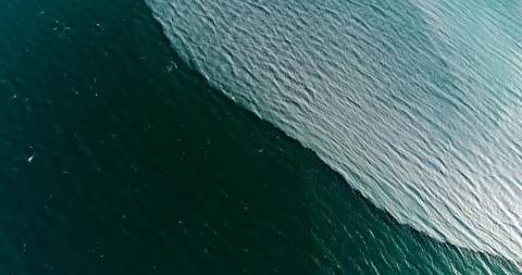 Cinematic drone fly over of glacial melt water mixing in deep blue fjord. Stock-Footage 113713331