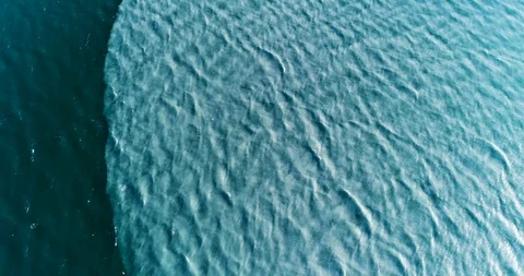 Cinematic drone fly over pan of glacial melt water mixing in deep blue fjord. Vídeo Stock 113714798