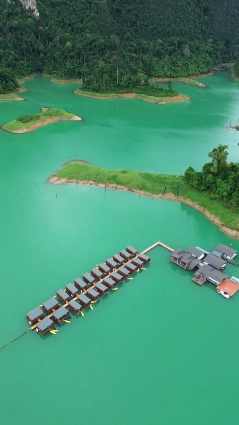 Cinematic drone flyover of floating bungalows with kayaks Stock Footage 336486561