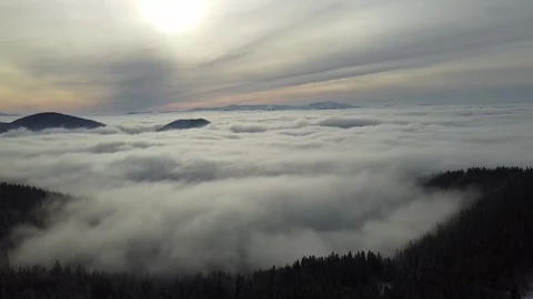Cinematic Drone Footage of Clouds Flowing Over Mountain Peaks Stock Footage 323944621