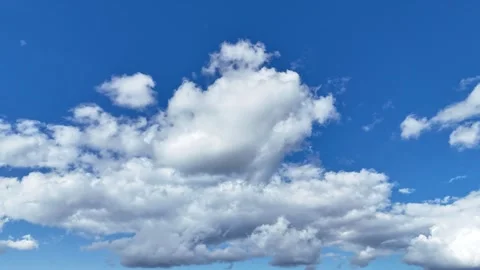 Cinematic drone hyperlapse of large clouds drifting across the sky Stock Footage 317911703