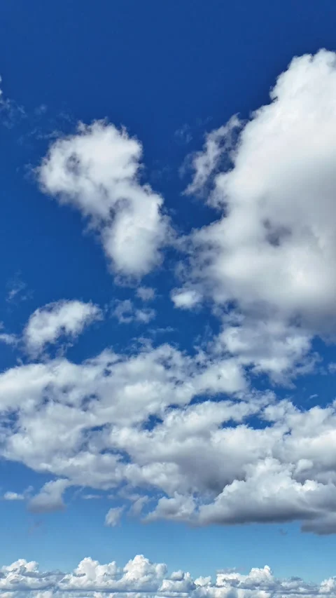 Cinematic drone hyperlapse of large clouds drifting across the sky Stock Footage 317911704