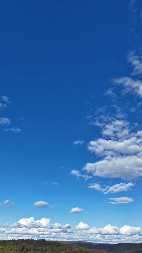 Cinematic drone hyperlapse of large clouds drifting across the sky 動画素材 317911832