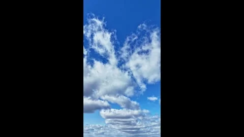 Cinematic drone hyperlapse of large clouds drifting across the sky. Vertical 4k Stock Footage 321823718