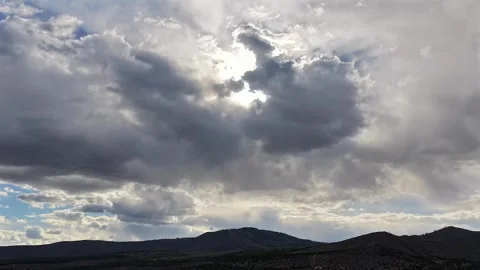Cinematic Drone Hyperlapse of Sun Backlit Ethereal Clouds Shifting over a Stockbeeldmateriaal 334189193