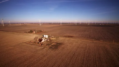 Cinematic drone movement around wind turbines mid-build Video stock 329222076