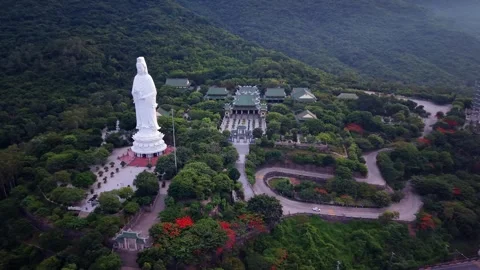 Cinematic drone orbit around Lady Buddha and Da Nang coastline Vietnam Stockbeeldmateriaal 340597548