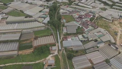 Cinematic drone orbit around moving train in Da Lat, Vietnam Video stock 319909640
