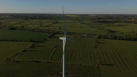 Cinematic drone orbit around wind turbine over scenic countryside landscape Stock-Footage 333935538