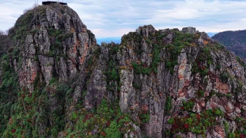 Cinematic Drone Orbit of Sharp Rock Peaks with Colorful Autumn Flowers, 4K Stock Footage 335076446